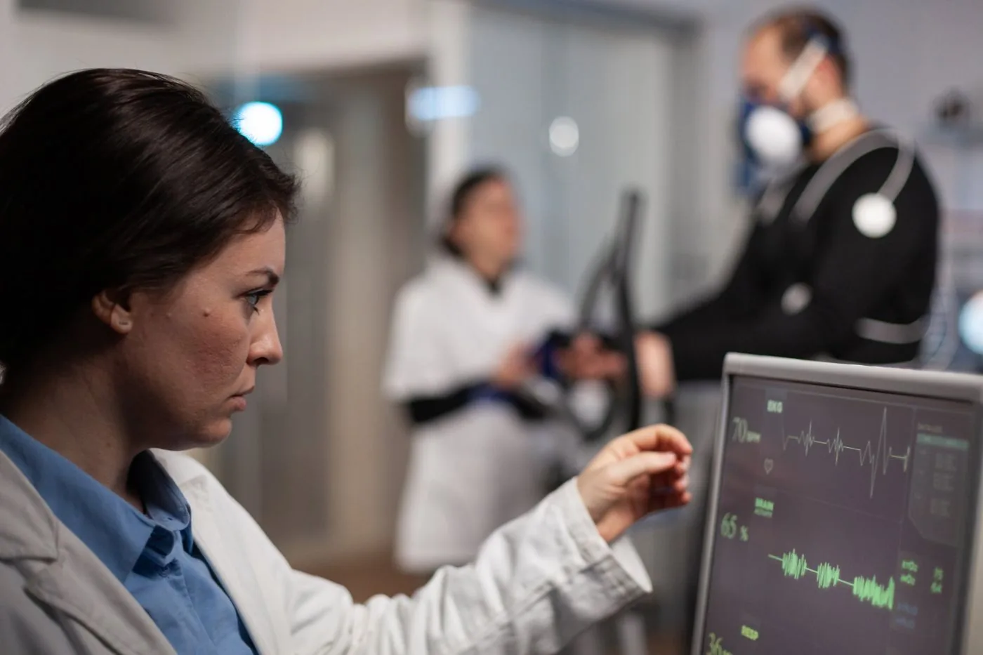 Clinician watching a heart monitor during an exercise test